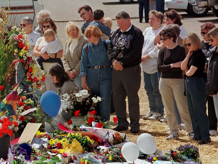 Mourners visit makeshift memorials for the Columbine High School victims a week after the shooting