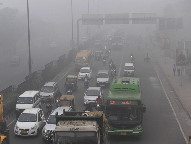 Commuters travel amid the smog in New Delhi