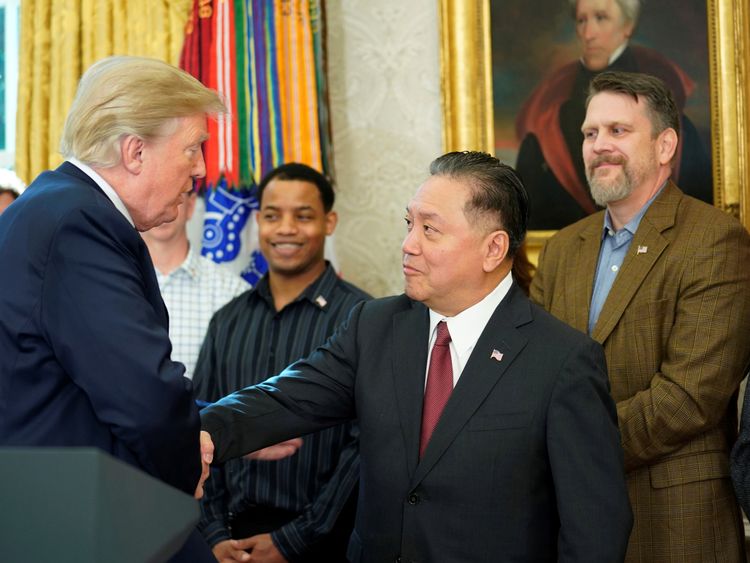 U.S. President Donald Trump shakes hands with Hock E. Tan, CEO of Broadcom