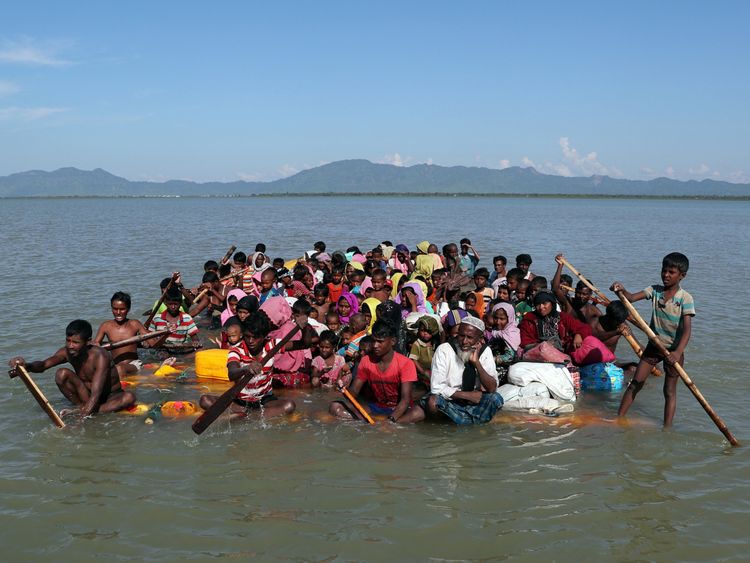 Rohingya refugees use a makeshift raft to reach Bangladesh