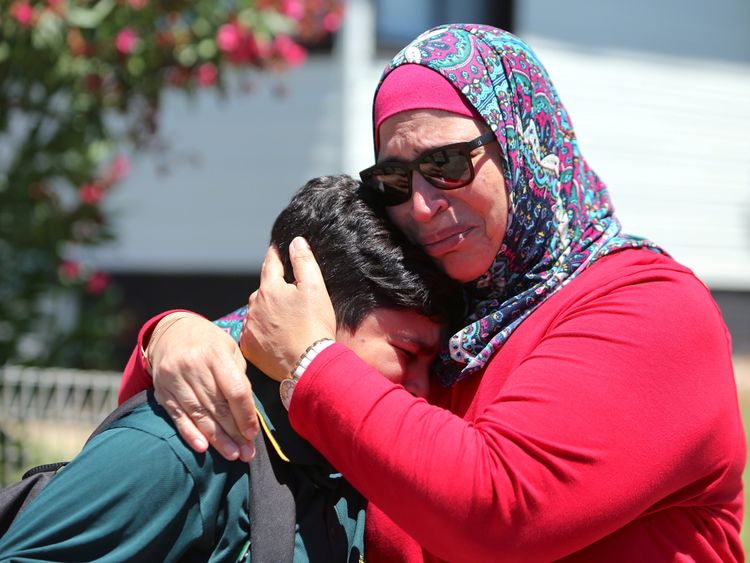 A woman and her son weep in the aftermath of the fatal crash