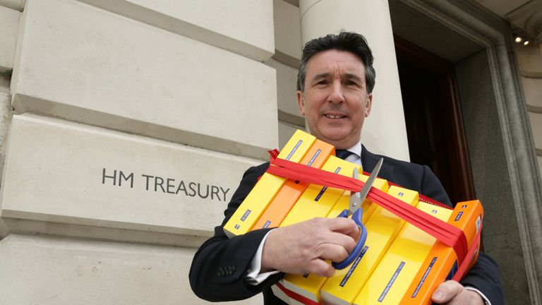 ICAS Chief Executive Anton Colella holding the books which comprise the UK tax code - which contain and up to 20,000 pages - outside the Treasury, in London, to call for simplification of the UK Tax Code. PRESS ASSOCIATION Photo. Picture date: Wednesday March 25, 2015. Photo credit should read: Yui Mok/PA Wire 