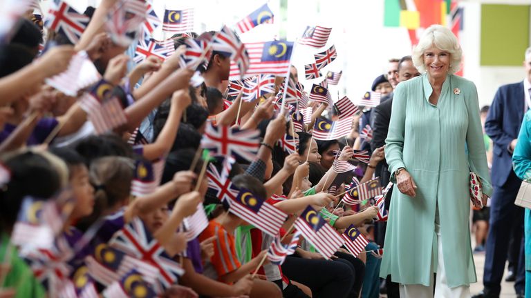 The Duchess of Cornwall is greeted by children at The International School