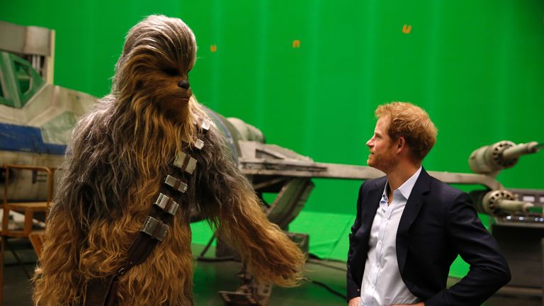 Britain's Prince Harry (R) meets Chewbacca during a visit to the Star Wars film set at Pinewood Studios near Iver Heath, west of London April 19, 2016