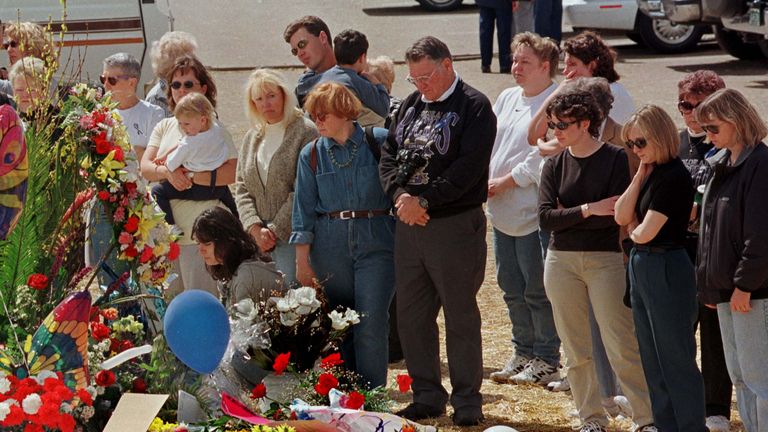 Mourners visit makeshift memorials for the Columbine High School victims a week after the shooting
