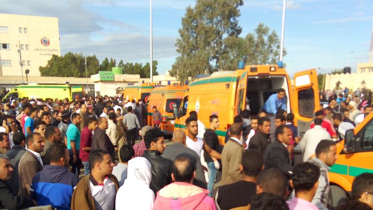 Egyptians crowd around ambulances following the gun and bomb attack