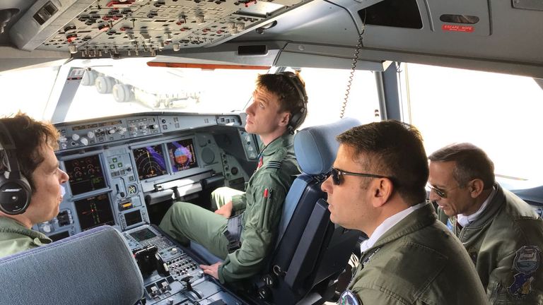 Argentine servicemen speak with RAF crew inside the cockpit of the plane. Pics: Guillermo Lobo
