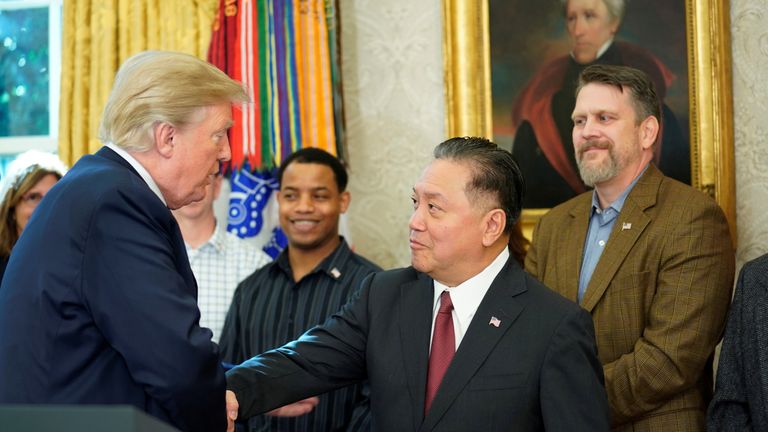 U.S. President Donald Trump shakes hands with Hock E. Tan, CEO of Broadcom