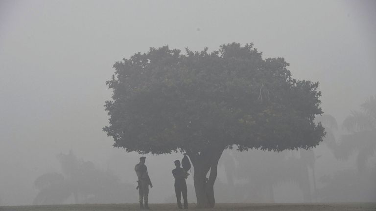 Indian security personnel stand guard at the Rajghat memorial amid heavy smog in New Delhi
