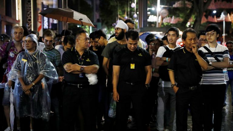 People queue overnight outside an Apple store in Singapore to get their hands on the device