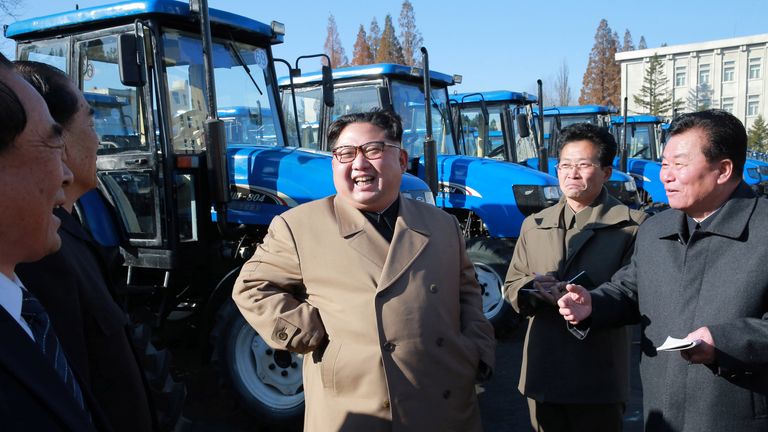 North Korean leader Kim Jong Un laughed with tractor factory bosses in his first public outing in two months
