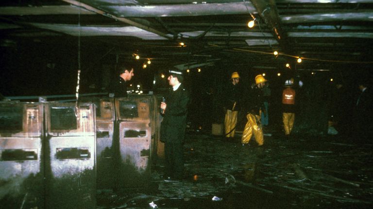 Police and fire officers in the fire-damaged ticket hall at King&#39;s Cross Underground Station, scene of a blaze in which more than 30 people perished.