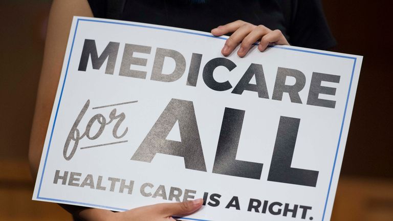 A member of the audience holds up a placard as US Senator Bernie Sanders, Independent from Vermont, discusses Medicare for All legislation on Capitol Hill in Washington, DC, on September 13, 2017. The former US presidential hopeful introduced a plan for government-sponsored universal health care, a notion long shunned in America that has newly gained traction among rising-star Democrats