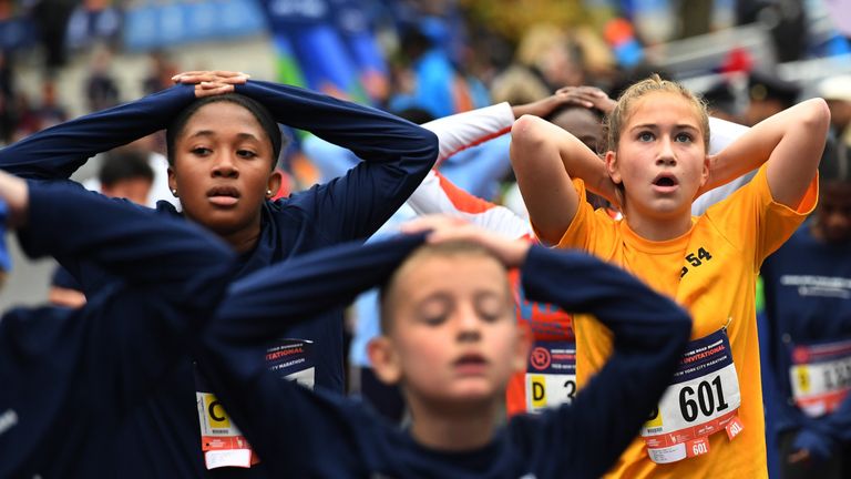 Children run the final portion of the marathon, ahead of the official start