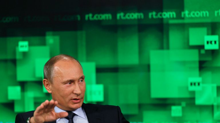 Russia&#39;s President Vladimir Putin speaks during his visit to the new studio complex of the state-owned English-language Russia Today television network in Moscow, on June 11, 2013. AFP PHOTO/ POOL/ YURI KOCHETKOV (Photo credit should read YURI KOCHETKOV/AFP/Getty Images)
