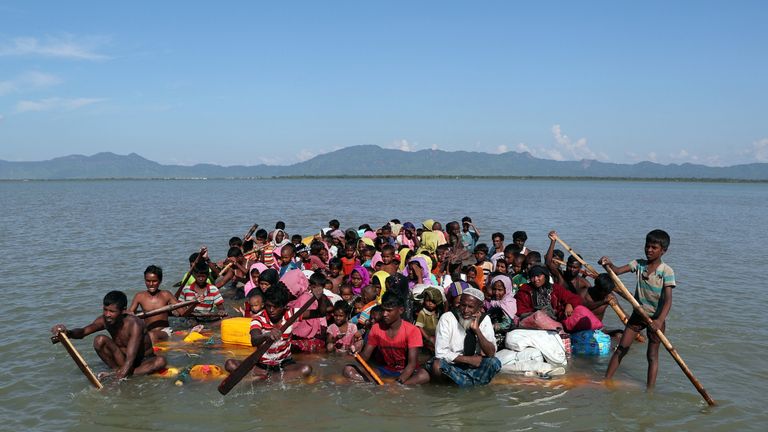 Rohingya refugees use a makeshift raft to reach Bangladesh