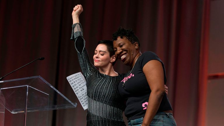 Actor Rose McGowan and Founder of #MeToo Campaign Tarana Burke, embrace on stage at the Women&#39;s March / Women&#39;s Convention in Detroit, Michigan, on October 27, 2017. / AFP PHOTO / RENA LAVERTY (Photo credit should read RENA LAVERTY/AFP/Getty Images)