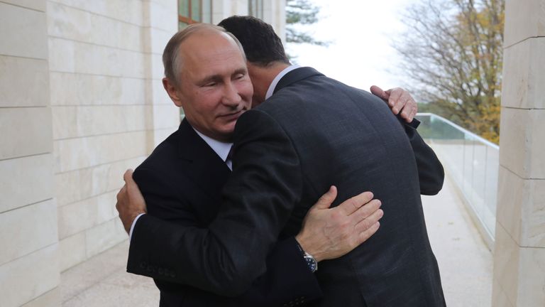 Russia&#39;s President Vladimir Putin embraces his Syrian counterpart Bashar al-Assad during a meeting in Sochi