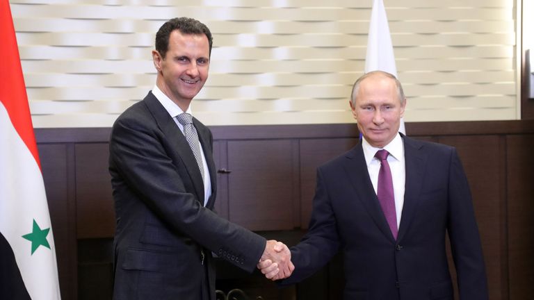 Russian President Vladimir Putin shakes hands with his Syrian counterpart Bashar al-Assad during a meeting in Sochi 