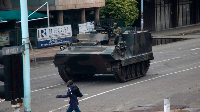 Zimbabwean soldiers stand at a junction as they control traffic in Harare