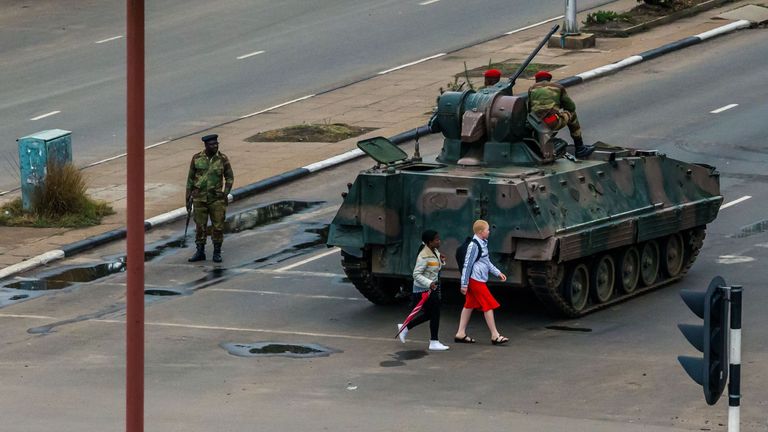 An armoured personnel carrier stationed by an intersection as Zimbabwean soldiers regulate traffic in Harare
