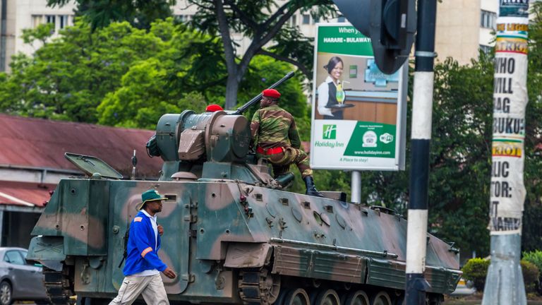 An armoured personnel carrier stationed by an intersection as Zimbabwean soldiers regulate traffic in Harare