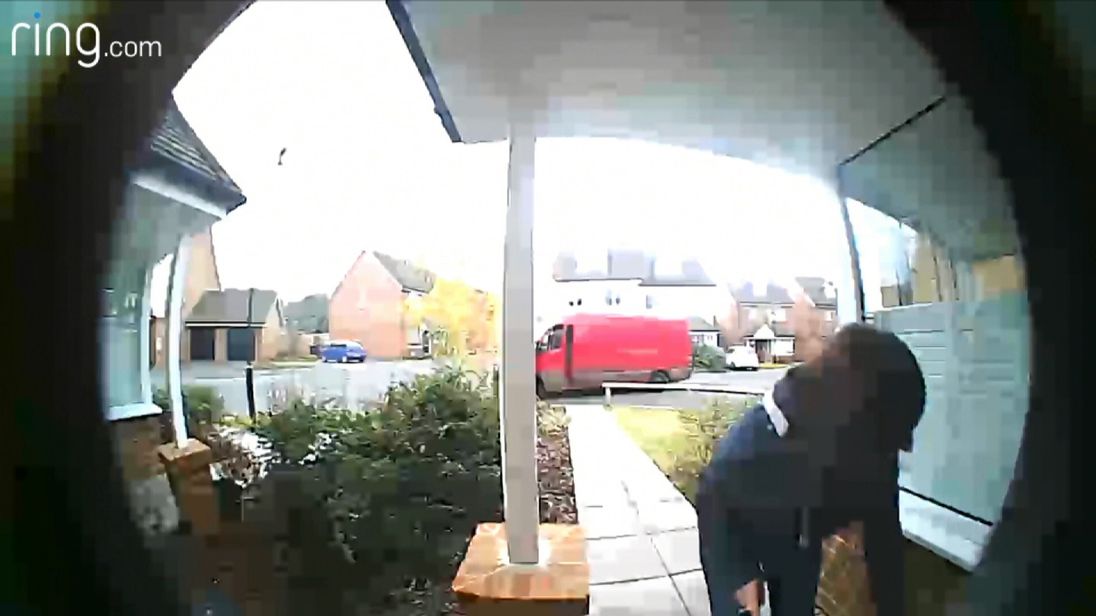 The woman is seen grabbing the parcel before jumping into a van
