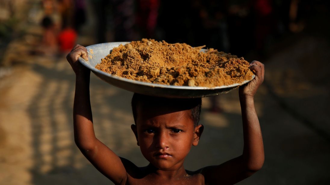A boy carries a tray on his head in one of the camps in Cox&#39;s Bazar