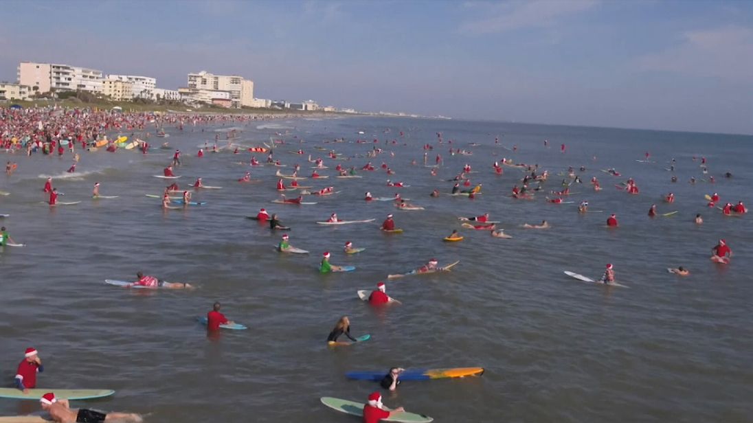 Hundreds of surfers dressed as Father Christmas took to the sea in Florida