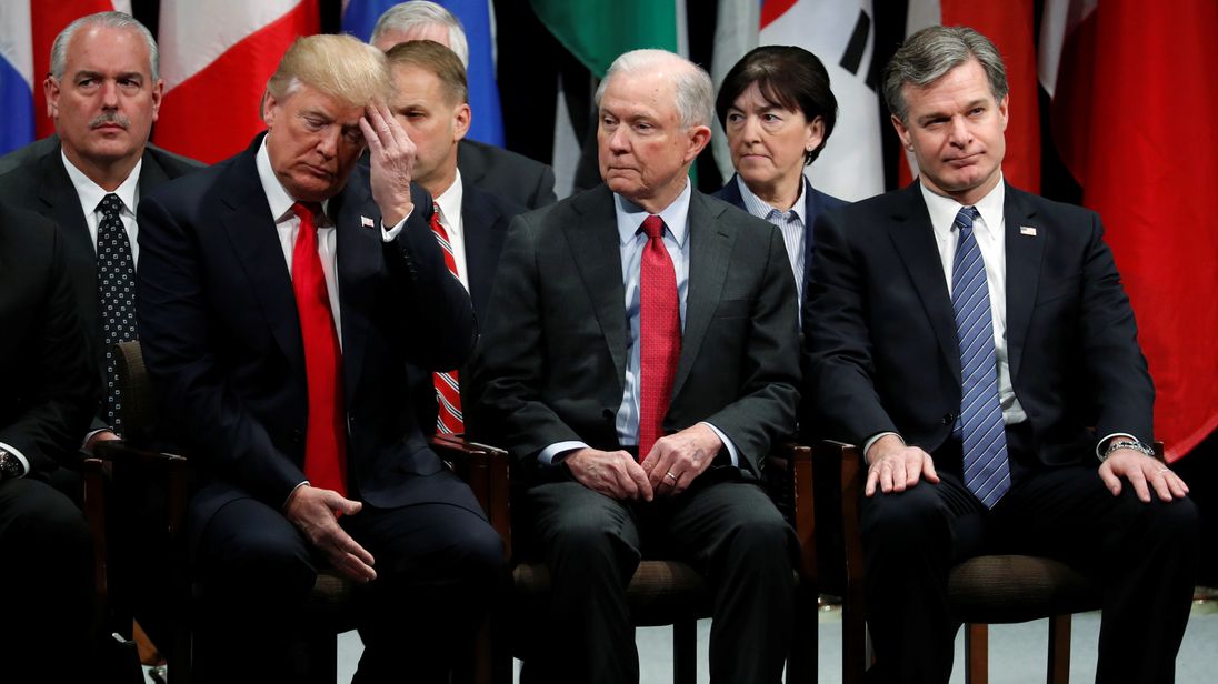 U.S. President Donald Trump, Attorney General Jeff Sessions (2nd R) and FBI Director Christopher Wray (R) in a graduation ceremony