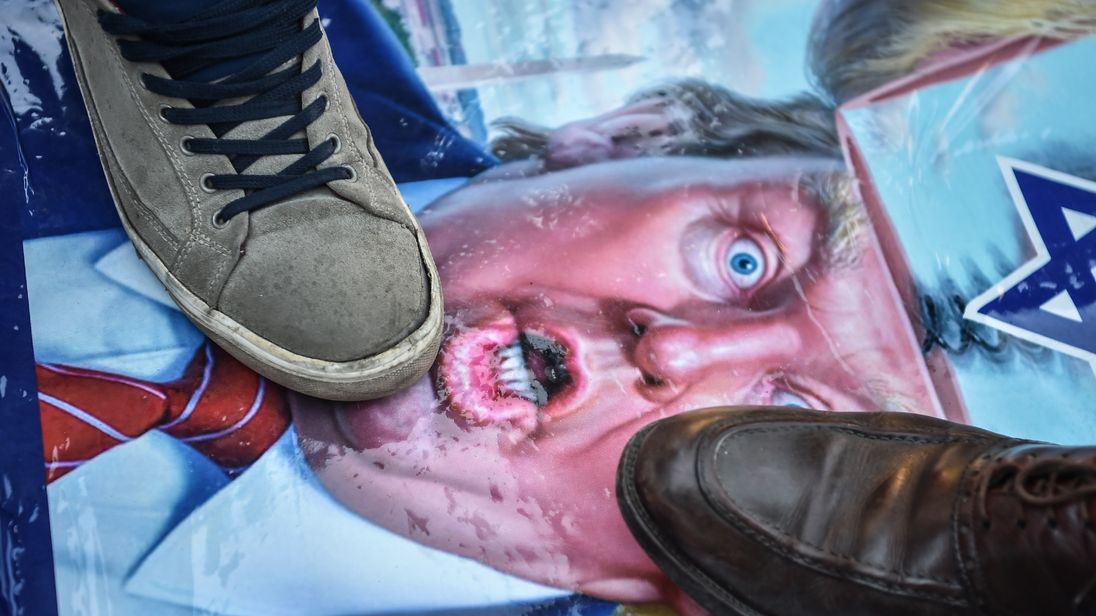 Protesters across the Arab world burned and stamped on images of President Trump