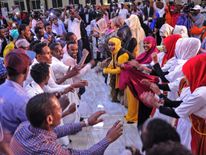 Somali women and men enjoy a traditional dance as they celebrate the coming 2018 on New Year's eve on December 31, 2017, in Mogadishu, Somalia