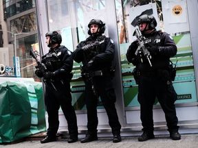 Armed police stand in Times Square following the botched bomb attack