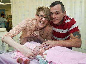 Three-week-old Vanellope Hope Wilkins with her delighted parents