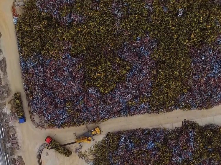 A crane is used to sort through the jumbled mass