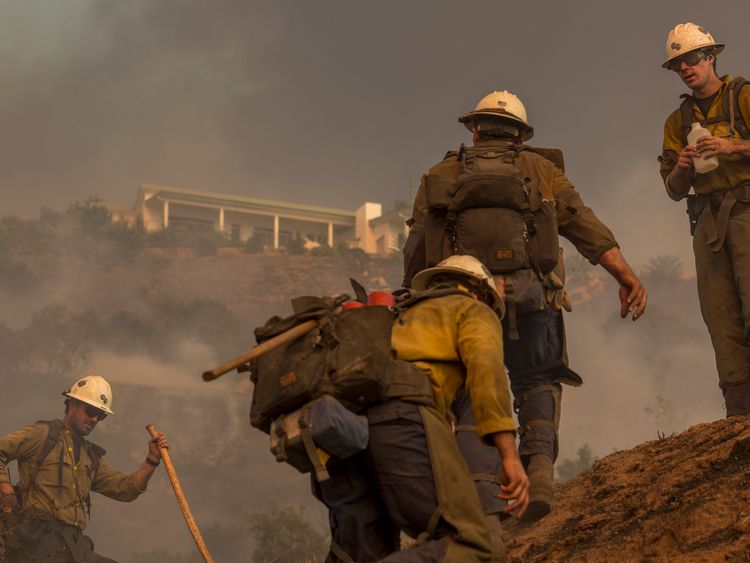  A Hot Shot crew climbs a hill while cutting a line among homes at the Thomas Fire on December 16, 2017 in Montecito, California. The National Weather Service has issued red flag warnings of dangerous fire weather in Southern California for the duration of the weekend. Prior to the weekend, Los Angeles and Ventura counties had 12 consecutive days of red flag fire warnings, the longest sustained period of fire weather warnings on record. The Thomas Fire is currently the fourth largest California 