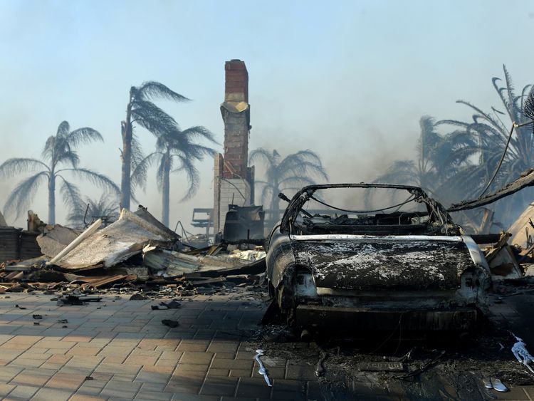 The remains of a home are seen, after it burned to the ground, during a wind-driven wildfire in Ventura