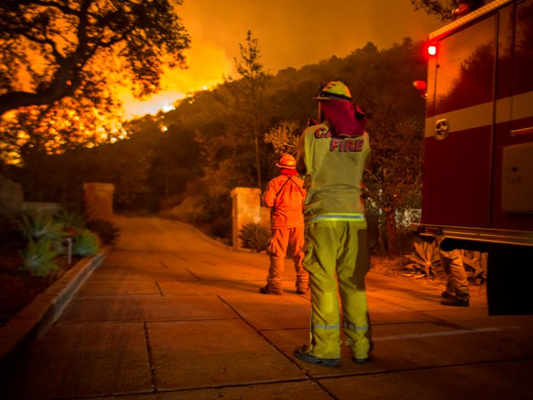 MONTECITO, CA - DECEMBER 12: Firefighters watch flames as the Thomas Fire approaches homes on December 12, 2017 in Montecito, California. The Thomas Fire has spread across 365 miles so far and destroyed about 800 structures since it began on December 5 in Ojai, California. (Photo by David McNew/Getty Images)