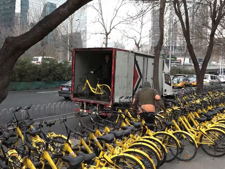Rows of brightly coloured bicycles can be seen all over Beijing