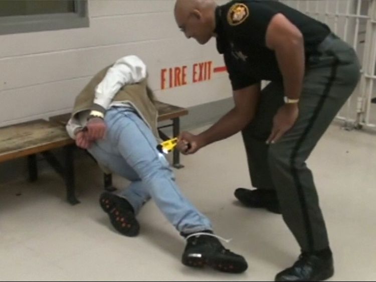 A guard at Franklin County Jail in Ohio presses a Taser gun into the leg of inmate in December 2009.