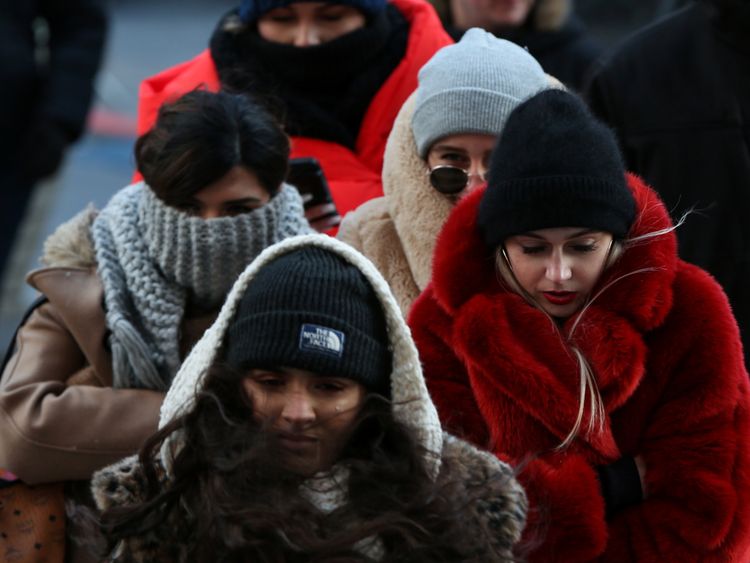 People wrap up against the cold in Times Square