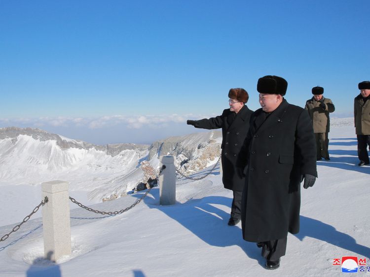 The leader wrapped up in the snowy conditions on Mount Paektu