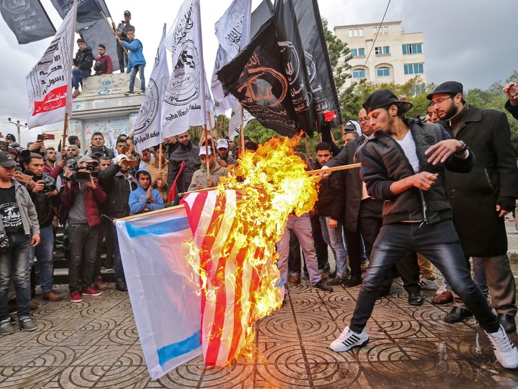 Palestinian protesters burn the US and Israeli flags in Gaza City