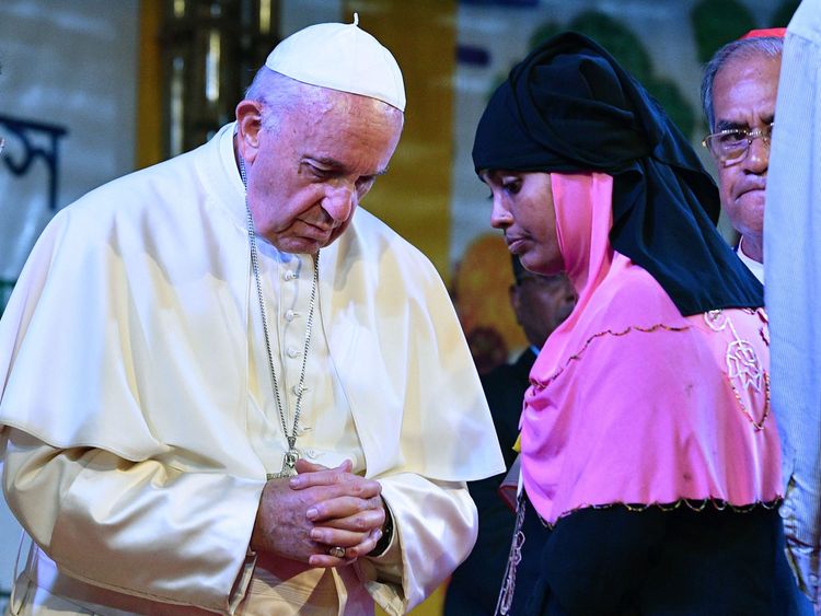 Pope Francis meets with a Rohingya refugee during an interreligious meeting at the Archbishop&#39;s house in Dhaka.