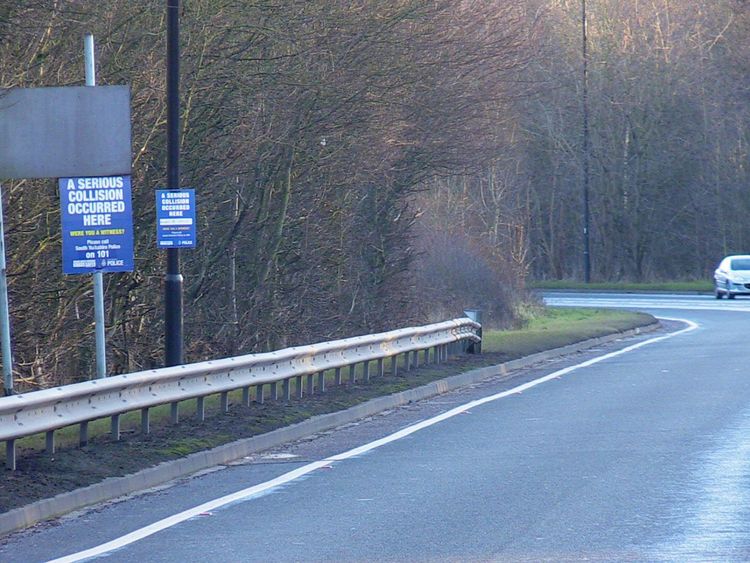 Witness appeal signs at the side of the road near the scene of a crash on the A57 in Sheffield