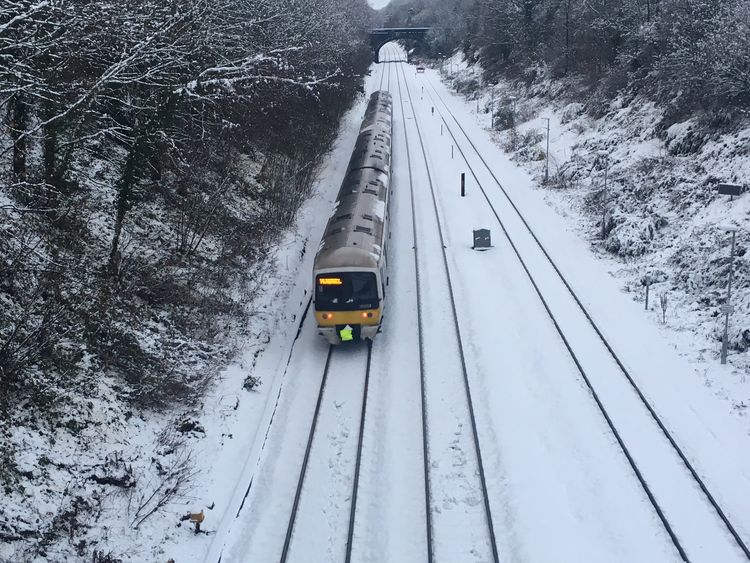 A train through the snow near Gerrards Cross in Buckinghamshire