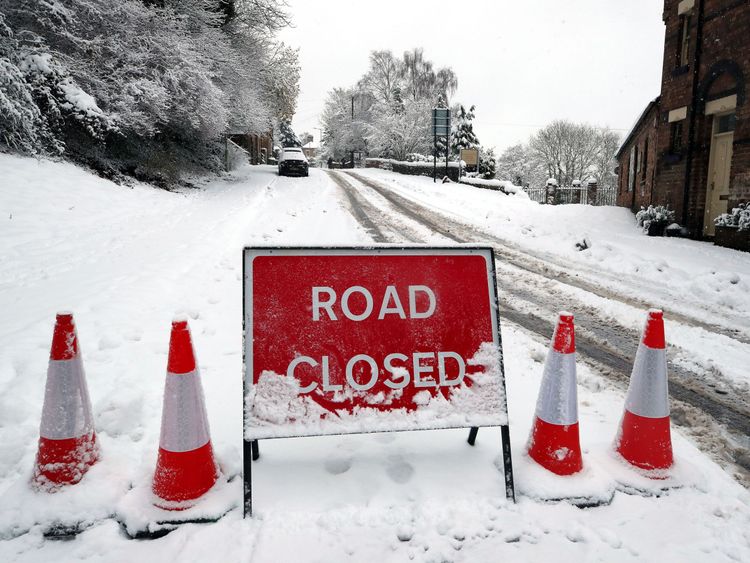 A road closed sign in snow covered Ironbridge in Shropshire, as heavy snowfall across parts of the UK is causing widespread disruption, closing roads and grounding flights at an airport.