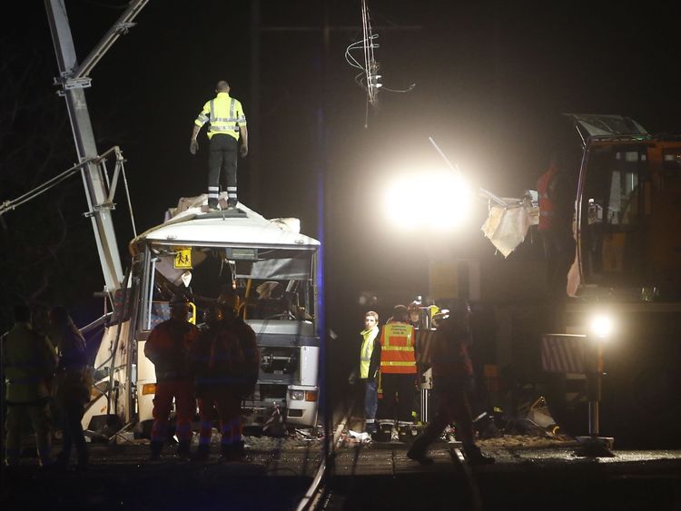 Firefighters and police at the site of an accident near Perpignan in southern France, where a train crashed into a school bus at a level crossing