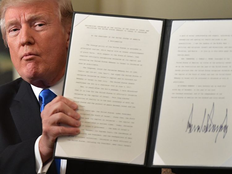 President Trump holds up a signed memorandum after he delivered his statement on Jerusalem