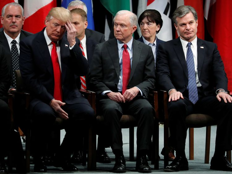 U.S. President Donald Trump, Attorney General Jeff Sessions (2nd R) and FBI Director Christopher Wray (R) in a graduation ceremony